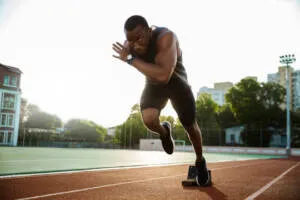 Sprinter launching off the starting blocks on a track