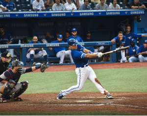 Baseball player hitting the ball in a stadium during a game
