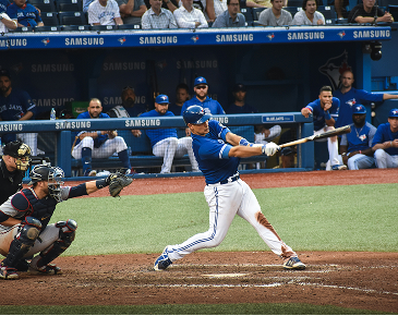 Baseball player hitting the ball in a stadium during a game