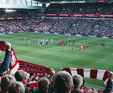 Shot from behind the crowd at a Liverpool game on the field