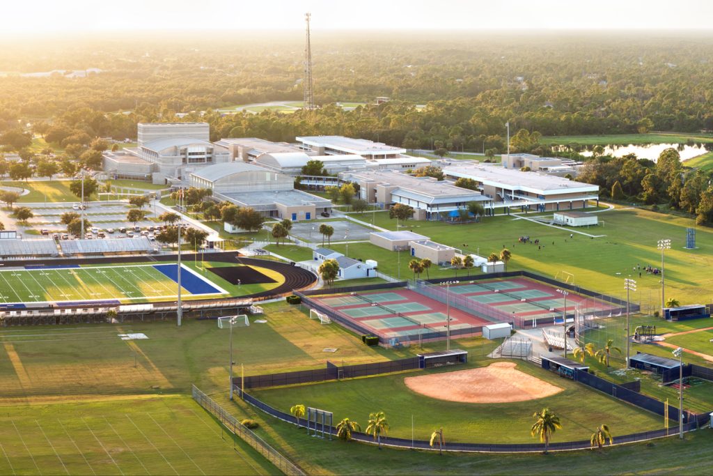 Sports facilities at a public school in North Port, Florida, including an American football stadium, tennis court, and baseball diamond