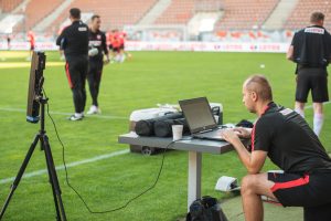 Person looking at a laptop during a training session for the European Youth Football Championship